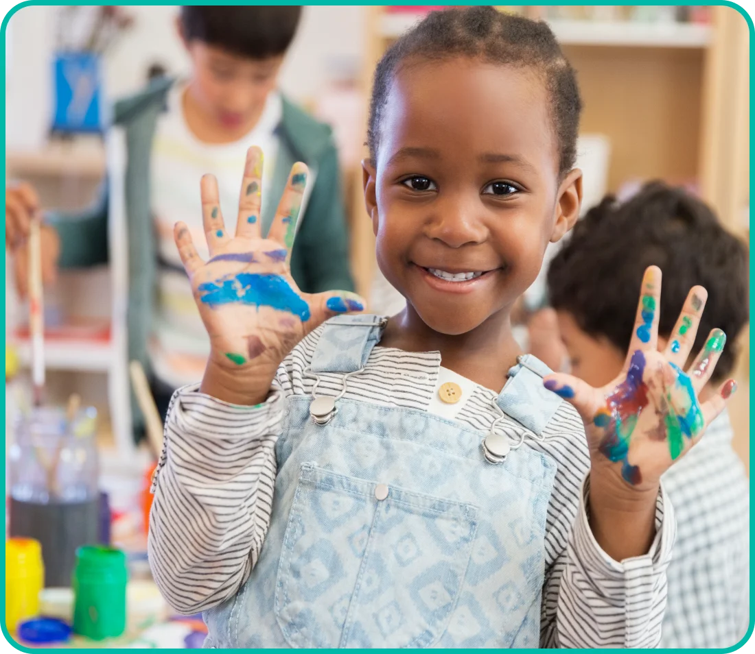 A little girl with her hands painted in the air.