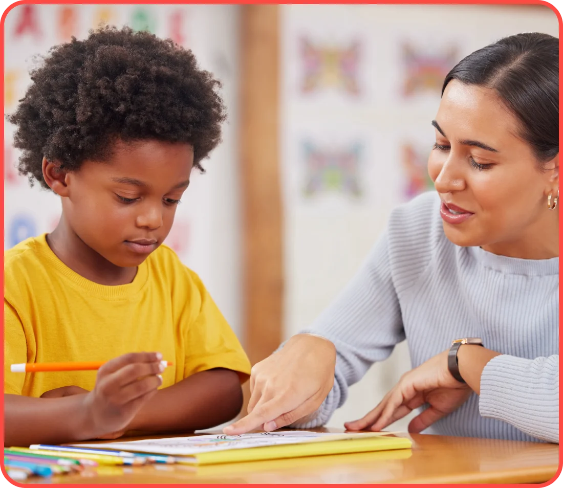 A woman helping a child with an art project.